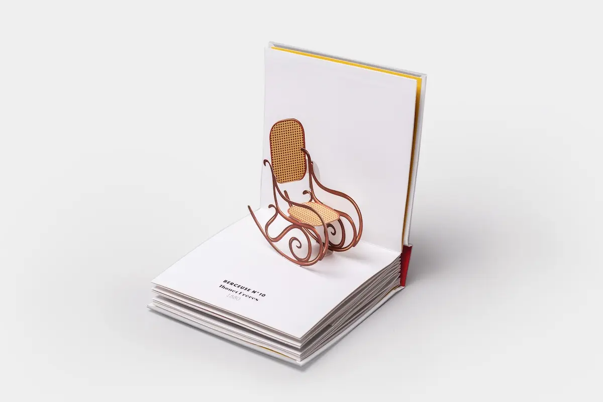 10 Chaises opened to a paper pop-up of Thonet's No. 10 rocking chair with bentwood curves and a cane seat